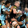 Dylan Edwards is swamped by the Cronulla kick-chase defence.
