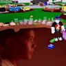 In a multiple exposure image, a 10-year-old Sydney boy looks at a game hosted on the Roblox platform.