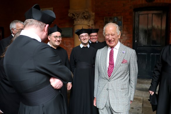 King Charles III laughs with Fathers during a tour of The Oratory of St. Philip Neri following the canonisation of Cardinal John Henry Newman in Birmingham.