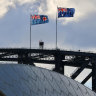 The flags of NSW and Australia atop the Sydney Harbour Bridge.