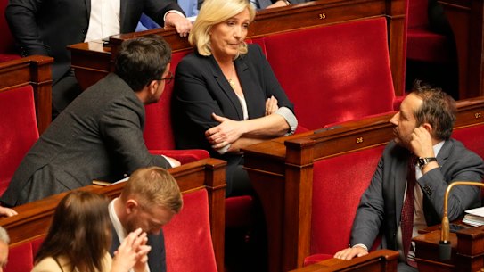 French far-right leader Marine Le Pen, centre, reacts at the National Assembly during a session on Tuesday.