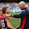 Bailey Laurie celebrates the Demons’ win with coach Steven King.