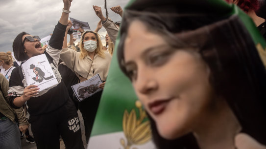 People hold signs and chant slogans during a protest against the death of Iranian Mahsa Amini and the government of Iran in Istanbul, Turkey.