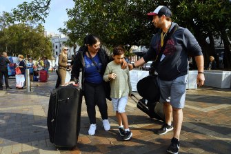 Helen Caudello (left) greets her son Anthony (right) and grandson Nicholas 8 (centre) as they disembark from The Ovation of the Seas cruise ship at Circular Quay.