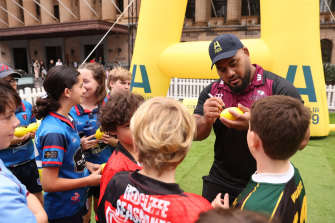 Taniela Tupou signs some autographs at a World Cup event in Brisbane.