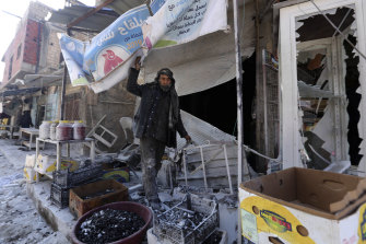A man sorts through the damage to a shop in the city of Saraqeb in the Idlib countryside after an air strike by Syrian aircraft last week. 