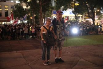 An elderly couple in front of the Cenotaph to mark the 74th Anniversary of the Liberation of Hong Kong.