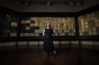 Artist Deanna Hitti with her installation of 156 cyanotype photos at the State Library.