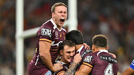 Delighted Brisbane players celebrate a try.