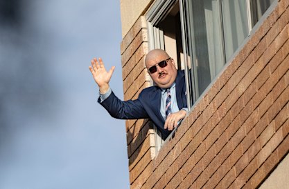 Simeon Boikov waves from the Russian consulate in Sydney, where he has been evading Australian authorities.