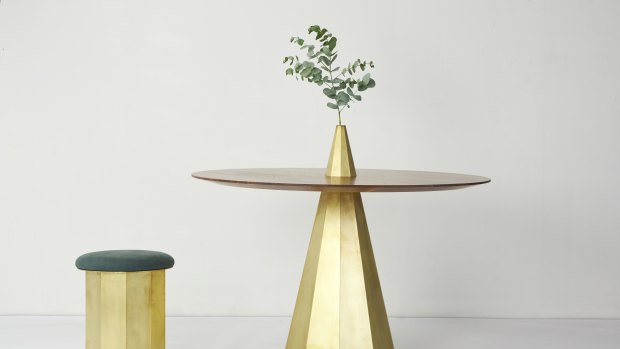 The dining table has elements of folded solid brass in a sculptural form, with a beautifully shaped top in oak or walnut timber. 