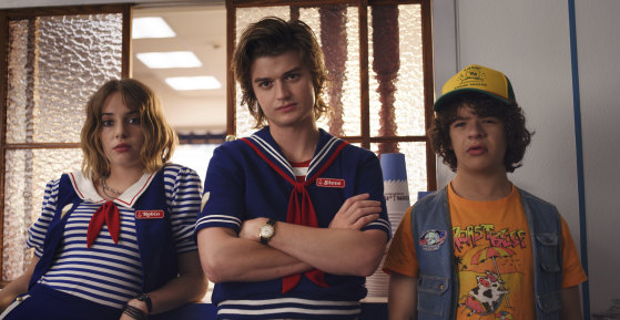 Maya Hawke as Robin (left) with Joe Keery and Gaten Matarazzo in season three of Stranger Things.