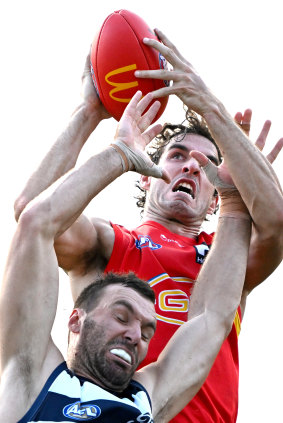 Despite dropping some marks, Suns key forward took this strong grab over Geelong’s John Ceglar.