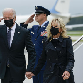 President Joe Biden returns a salute as he and first lady Jill Biden arrive at Dover Air Force Base on Sunday.