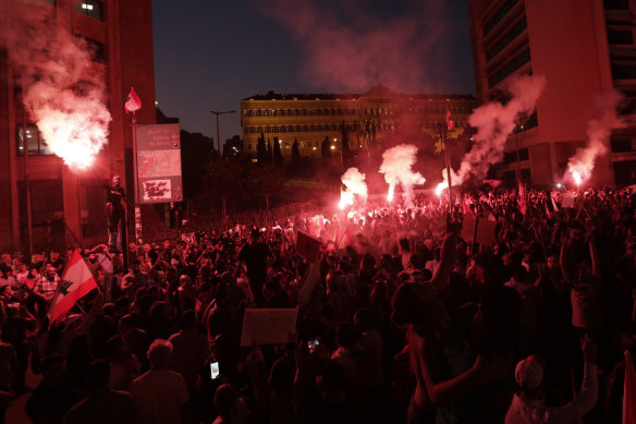 Anti-government protesters light flares and shout slogans in Lebanon's capital, Beirut, this week.