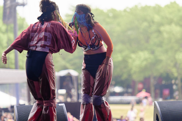 Haiku Hands’ Beatrice Lewis and  Claire Nakazawa prefer to cover their faces while performing. 