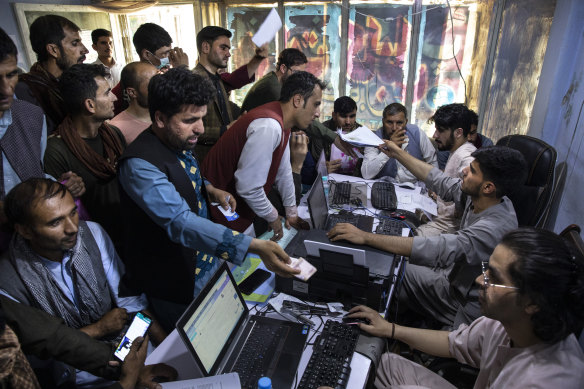 Special Immigrant Visa applicants crowd the Herat Kabul Internet cafe to apply for the SIV program on August 8. 