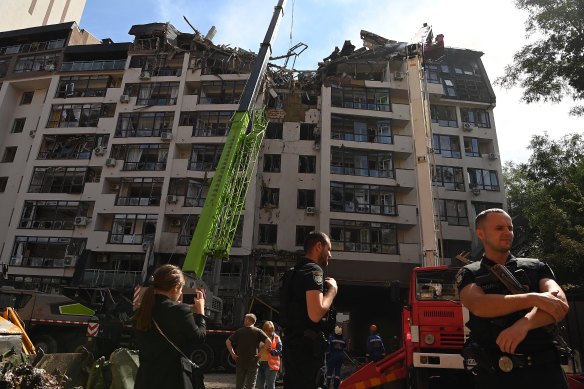 Emergency services in front of apartment building hit by a missile in central Kyiv in June 2022.