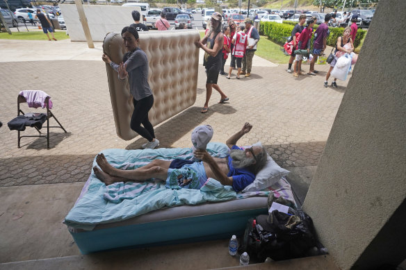 Thomas Leonard lies on an air mattress at an evacuation centre at the War Memorial Gymnasium on Thursday after his Lahaina apartment burned down.