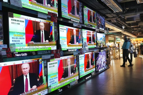 TV screens broadcast news of Russian troops in Ukraine, in Hong Kong. As Russia intensifies its assault on Ukraine, it is getting a helping hand from China in spreading propaganda.