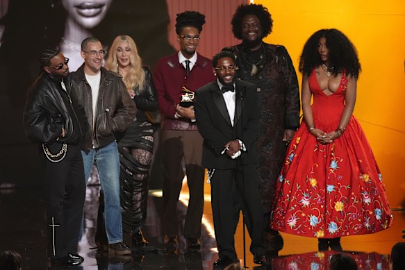 From left, Sounwave, Jack Antonoff, (presenter Cher,) Scott Bridgeway, Kendrick Lamar, Kamasi Washington and SZA accept the award for record of the year for Luther.