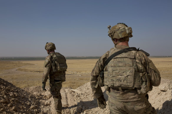US soldiers pictured last month surveying the safe zone between Syria and the Turkish border near Tal Abyad, Syria.