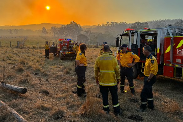 End of day: crew members take stock after a day of dousing flames and strengthening containment lines.