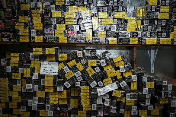 Boxes of legal cigarettes inside the storage room of a tobacco shop.