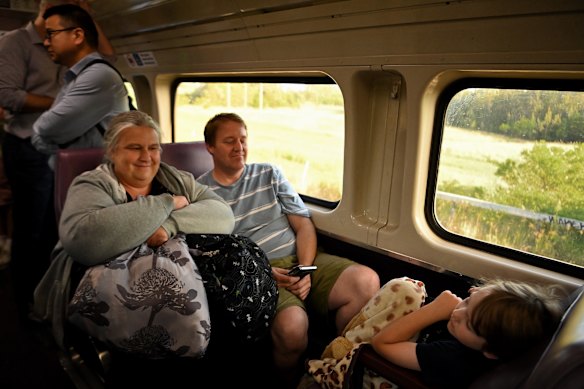Crystal Parker (left) with her husband Ben Parker and their sleeping son Luke Parker (right) on the last V-set train.