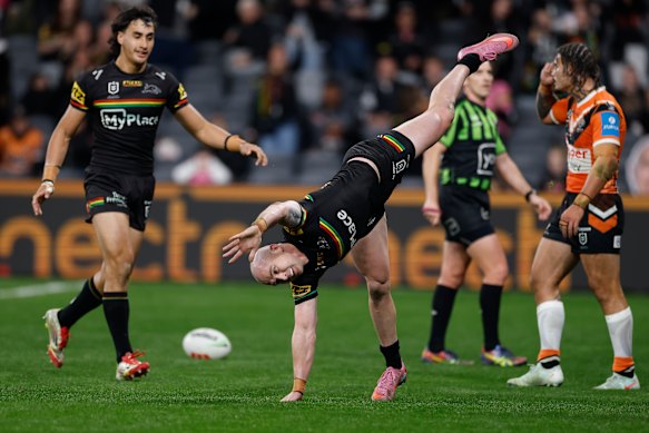 Dylan Edwards does a cartwheel after scoring a try.