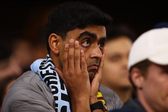 A disappointed City fan watches on.