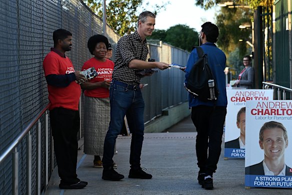Member for Parramatta Andrew Charlton hands out flyers at the train station at Harris Park. 