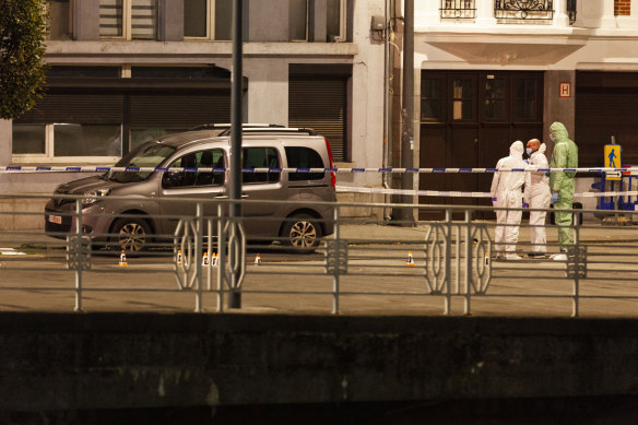 Police and inspectors work in an area where a shooting took place in the centre of Brussels.