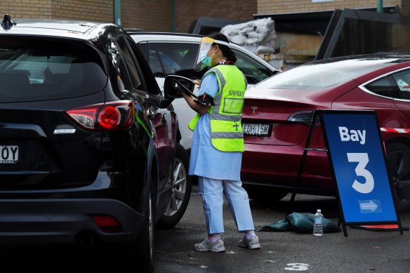 Staff at the Summer Hill drive-through COVID-19 Clinic register in NSW.