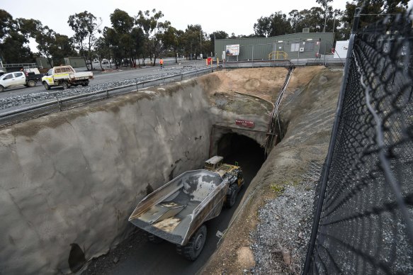 Trucks enter the mine. A full tray of rock produces about two teaspoons of gold.