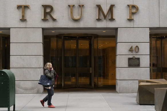 A woman walks by The Trump Building in New York’s financial district.
