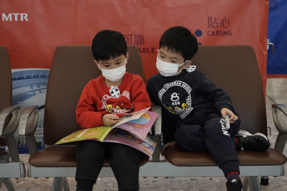 Passengers wear masks in the high speed train station in Hong Kong.