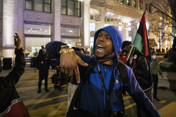 Dozens of protesters march down the Magnificent Mile on Thursday evening after Chicago released videos of 13-year-old Adam Toledo being fatally shot by a Chicago police officer. 
