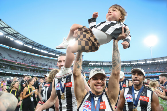 Norm Smith medallist Bobby Hill celebrates with Bobby Hill jnr.