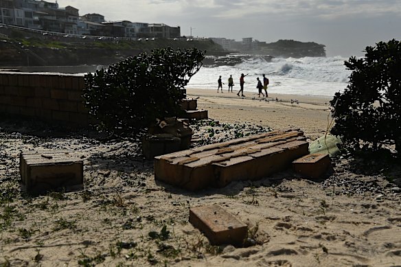Brick walls at Bronte Beach were damaged when waves hit, sending debris flying metres beyond the footpath.