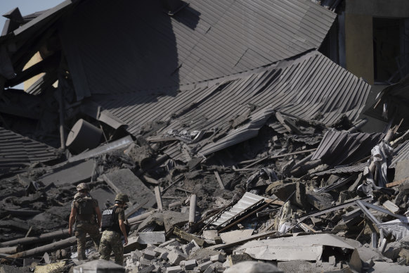 Ukrainian servicemen walk on the debris of a heavily damaged school after a Russian attack in Druzhkivka, Donetsk region, eastern Ukraine.