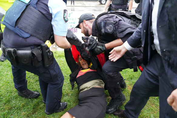 Lidia Thorpe is restrained by police after attempting to disrupt British anti-transgender rights activist Kellie-Jay Keen-Minshull.