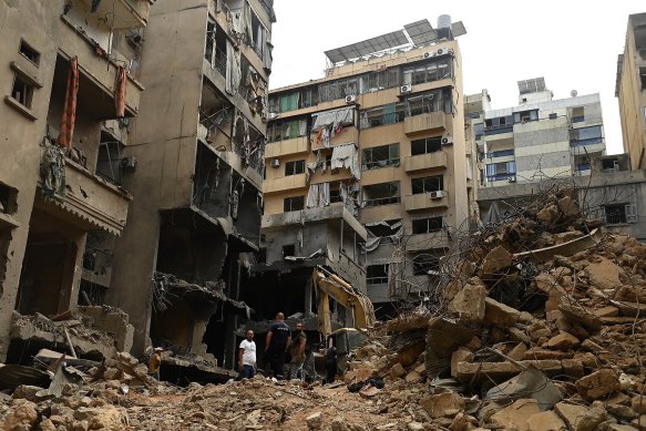 Searching for people at the site of an Israeli airstrike in Beirut’s el-Basta suburb that killed 22 people and injured 117 others.