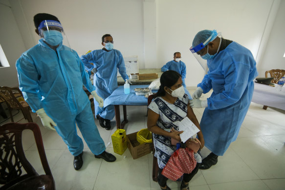 Sri Lankan health workers administer second doses of Sinopharm in Colombo, Sri Lanka in mid June.