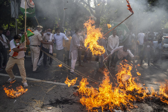 An effigy of Uttar Pradesh chief minister Yogi Adityanath is burned during a protest.