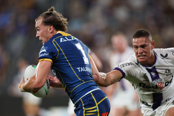 The Eels’ Clinton Gutherson (left) comes under pressure from Storm’s Will Warbrick in the NRL season-opener.