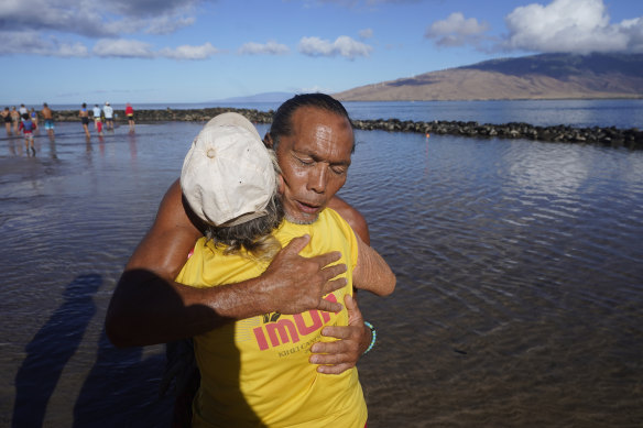 Vicente Ruboi receives a hug after performing a blessing to greet the day in Kihei, Hawaii.