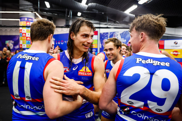 Bulldogs players celebrate the club’s crucial win.