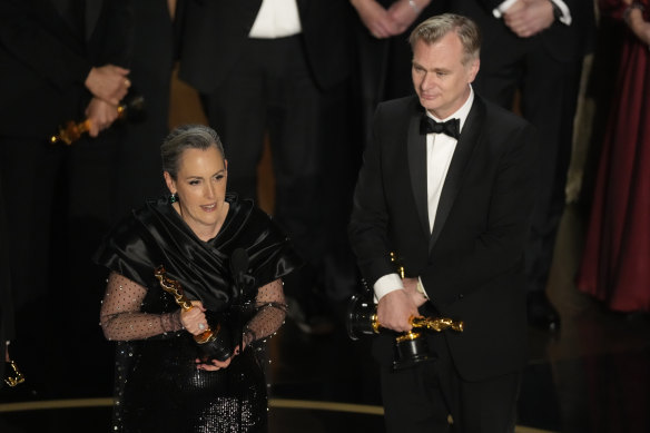 Emma Thomas and Christopher Nolan accept the best picture award.