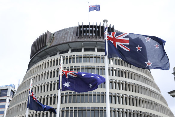 New Zealand and Australian flags fly in front of the NZ parliament in Wellington.
